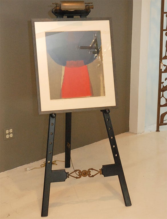 Great mid-century  easel. Adjustable pegs for easy height adjustment for placing art. Built-in brass picture light. Lithograph available for $550.