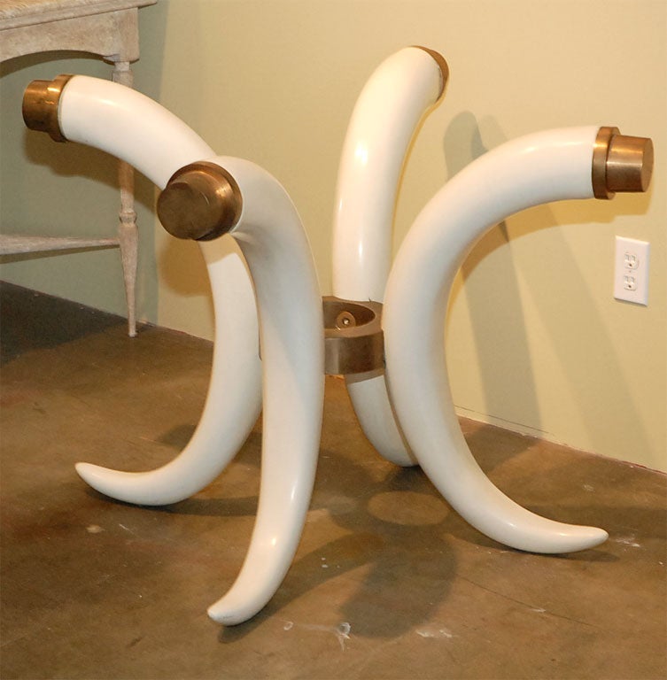 Faux ivory tusk table base with brass hardware, correct height for use as dining table or center/foyer table.