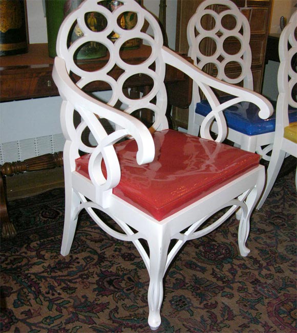 A set of six American carved and white painted wood “loop” dining chairs inspired by an 18th century Chinese Chippendale model comprised of one pair of open arm chairs with slip seats dating to 1940 and four side chairs and two armchairs with caned