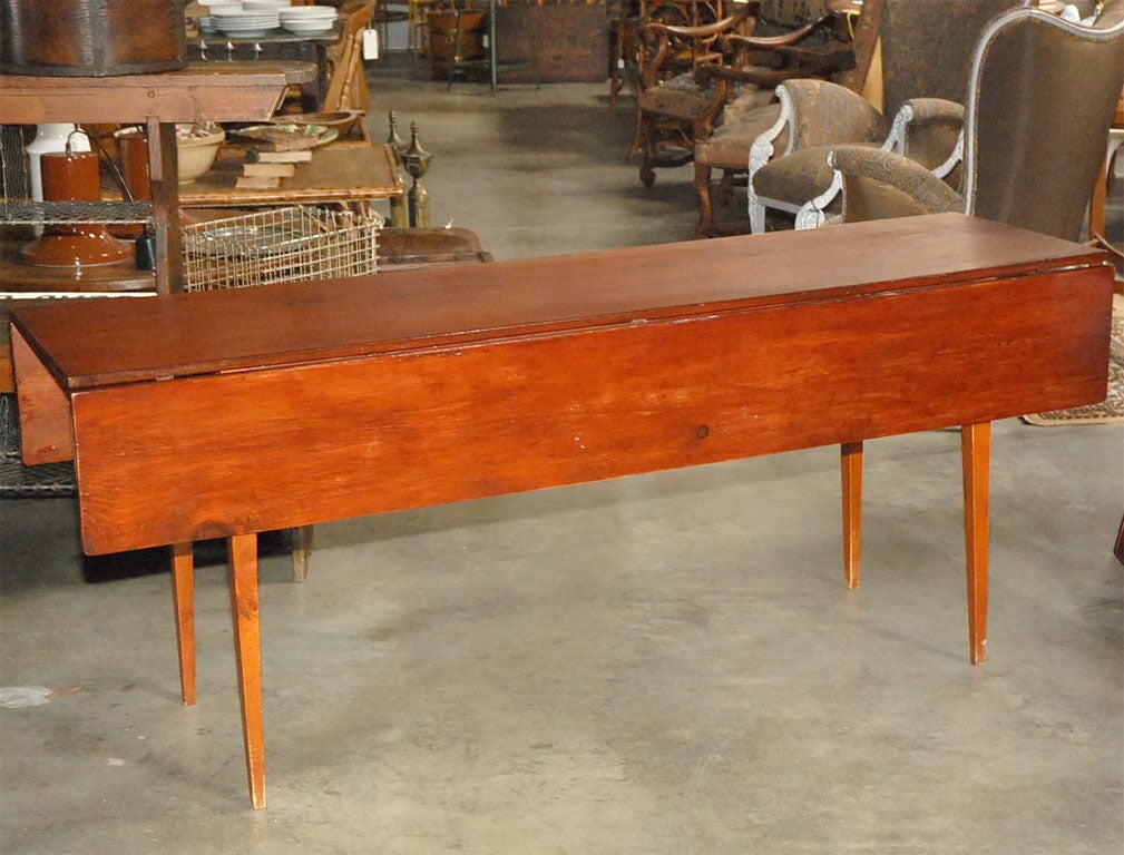 This Hepplewhite style table in cherry has a single board (20 1/2