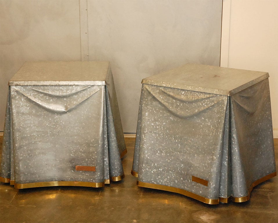 These are the smaller version of the popular skirted metal tables that John Dickinson placed into various settings in the 1970's. The tables are actually galvanized metal shaped to look like draped cloth. Each table has a 