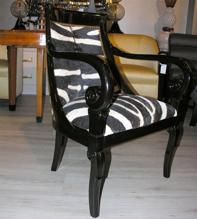 Pair of Zebra Hide and Ebonized Carved Mahogany Armchairs