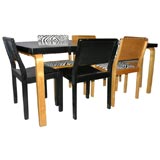 A birch dining table and 8 dining chairs by Alvar Aalto