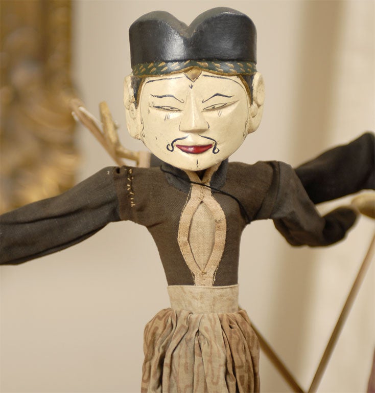 Although later versions of these pop up on the market, this pair of puppets is very early: probably early 20th century.  This is noted because of both the wood construction underneath as well as the cloths used for their clothes.  They are
