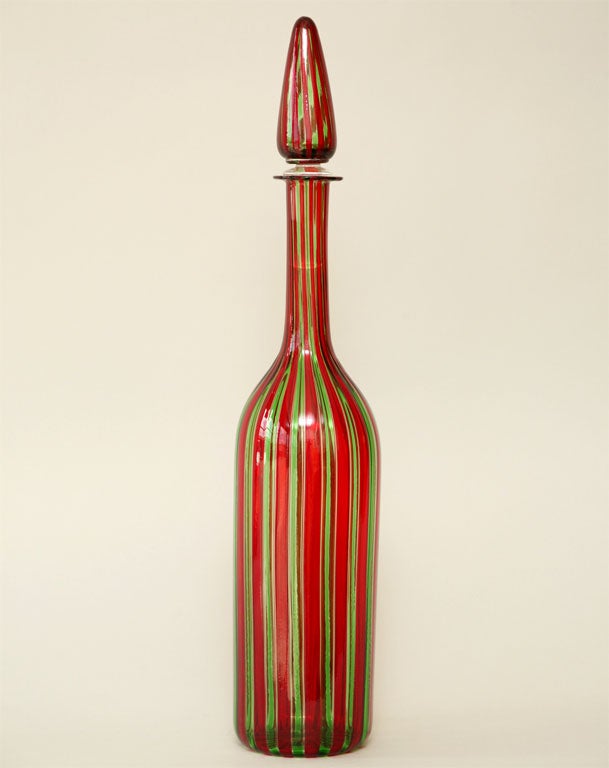 Bottle with stopper designed by Paolo Venini.Red and green stripes.Signed on the bottom.