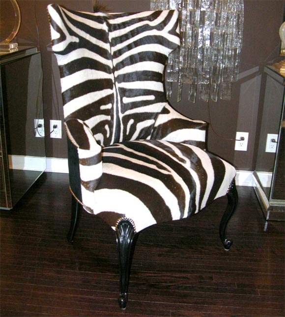 Amazing pair of genuine zebra hammerhead chairs with carved legs and black suede back, available for custom orders. Each chair we make will be very unique due to different coloration and patterns that are natural to genuine zebra skins.
