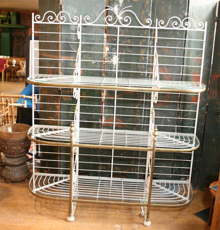 This bakers rack is of a good size being not to large. It has not only the original removable open work iron shelves but also has glass shelves cut so that either may be used as desired