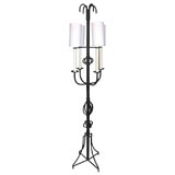 Black iron floor lamp in the style of  Tommi Parzinger