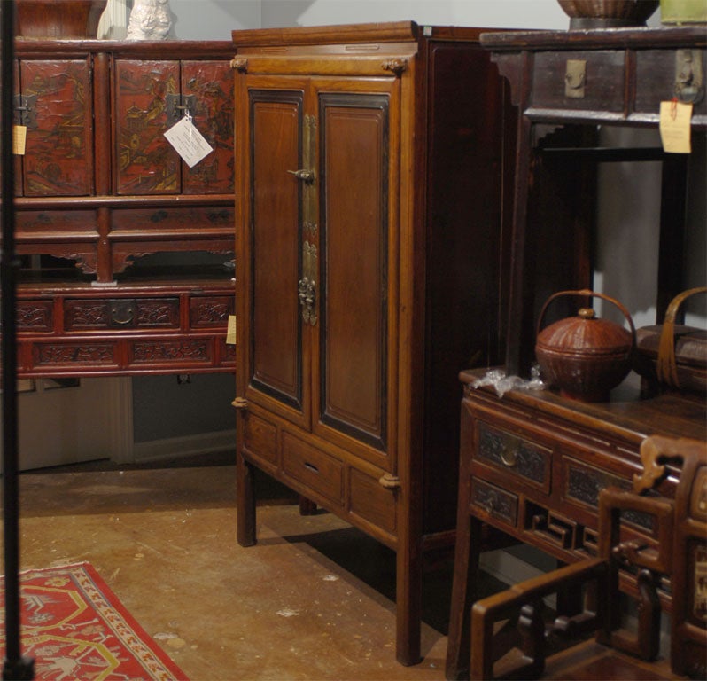19th Century Qing Dynasty Ningbo Large Cabinet of Rosewood with wonderful carving on the door hinges and original etched hardware.  The inside holds one shelf containing two drawers and one removeable shelf.  There is also another drawer at the