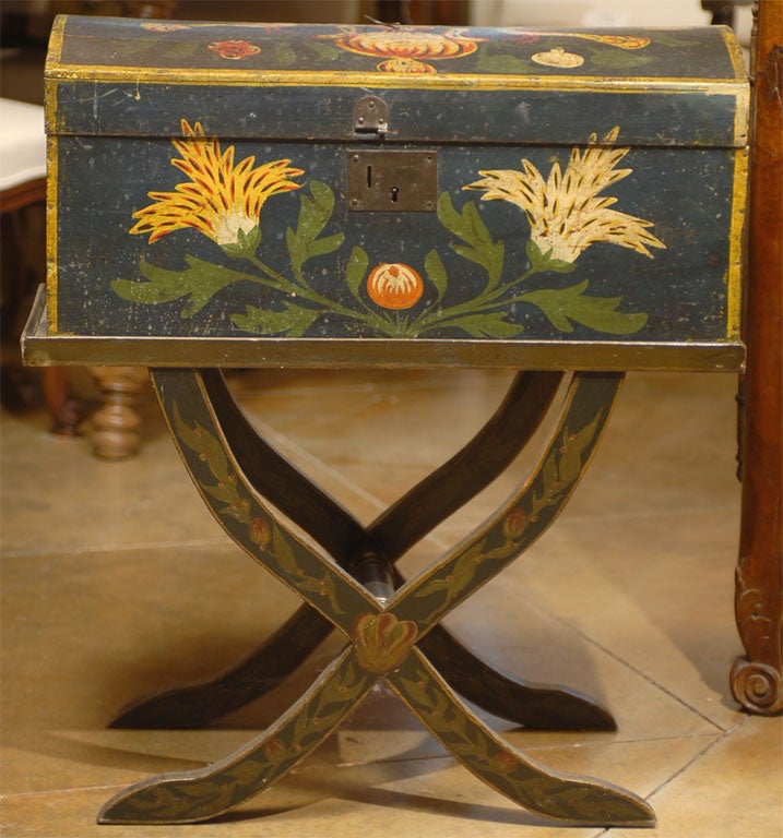 18th century French painted marriage box on stand from Normandy with vibrant paint and black background.