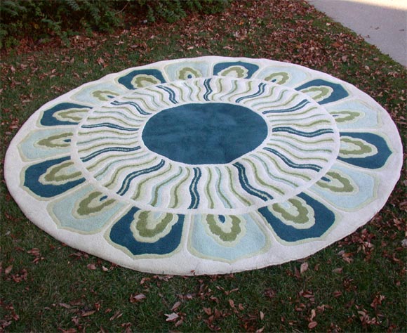 handwoven rug, round form with blue and green decoration on a cream field