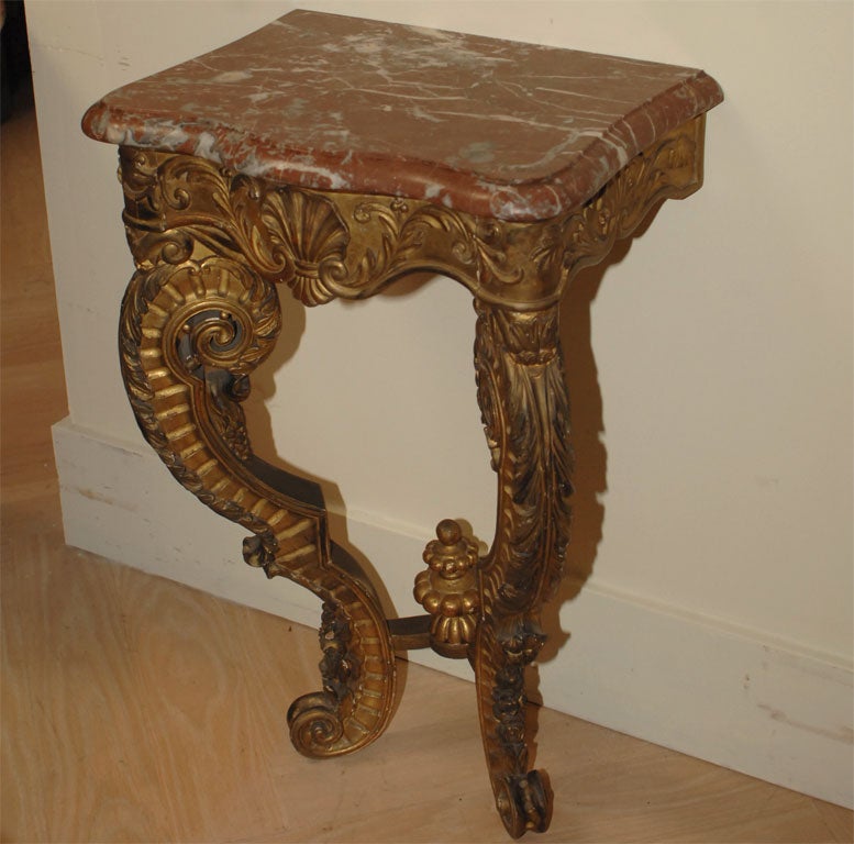 A pair of 19th century, Italian giltwood consoles with marble tops. These have a hidden later drawer added to the frieze. They are nice and small in scale and with the drawer make a nice bedside tables. Less than 2% of our inventory is shown here