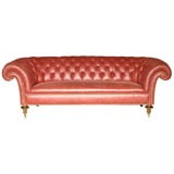 A Victorian Walnut and Ebonized Chesterfield Sofa-