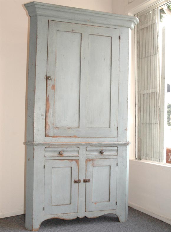 GREAT POWDER BLUE TWO PIECE CORNER CUPBOARD FROM PENNSYLVANIA IN PRISTINE CONDITION,ALL ORIGINAL HARDWARE AND PEG & SQUARE NAIL CONSTRUCTION .THIS CUPBOARD HAS WONDERFUL CUT OUT SKIRT AND FULL HEIGHT TO THE FEET,THE CUPBOARD IS MADE OF PINE AND