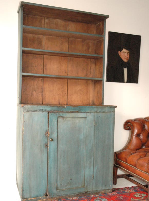 EARLY AND RARE 19THC ORIGINAL BLUE PAINTED OPEN STEP BACK CUPBOARD IN AS FOUND CONDITION. WONDERFUL EARLY HAND MADE ROSE HEAD & SQUARE NAIL CONSTRUCTION.ALL ORIGINAL HARDWARE AND HINGES.THE SURFACE ON THIS EARLY COUNTRY CUPBOARD IS THE VERY BEST!