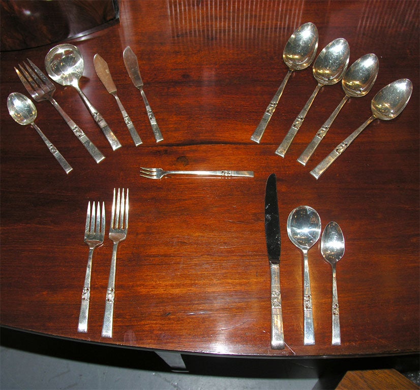 Someone loved this set.  There is serving for 12 PLUS serving pieces.  It was well taken care of.  This silverplate set has a lovely organic pattern. Four bars and top and four below frame the pattern.   The plate is in very good shape.  12 forks.