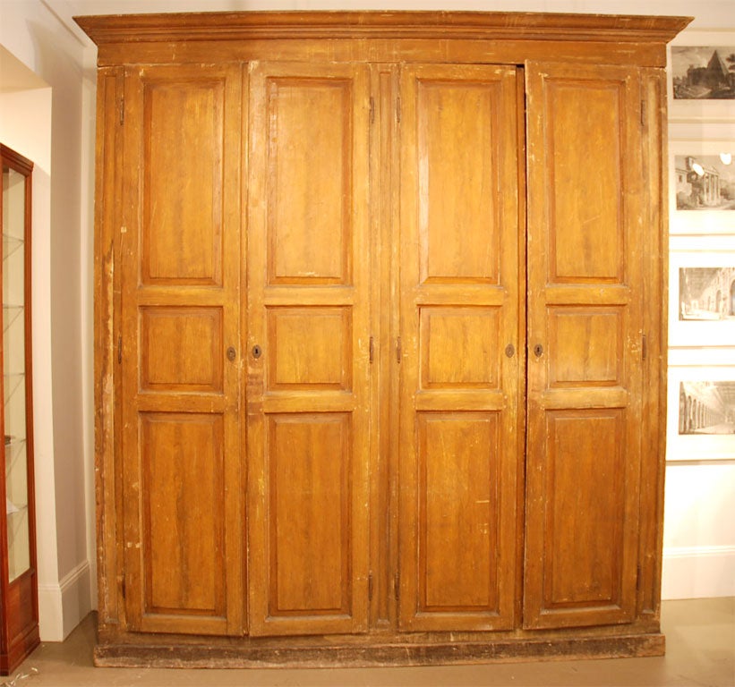 A Large scale Italian faux grain painted wardrobe retaining its original surface and hardware. Shelves and back have been replaced.