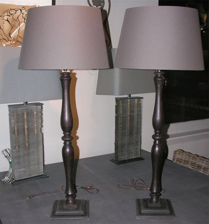 a pair of lamps made from antique architectural parts