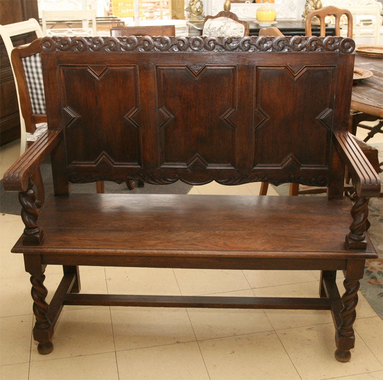Beautifully hand carved high back bench with twist turned legs and plank seat.  <br />
Great as entry hall bench or library piece.