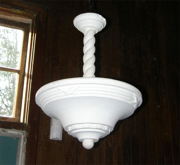 Conical form plaster up light with bundled reed ornamentation. It is not electrified.