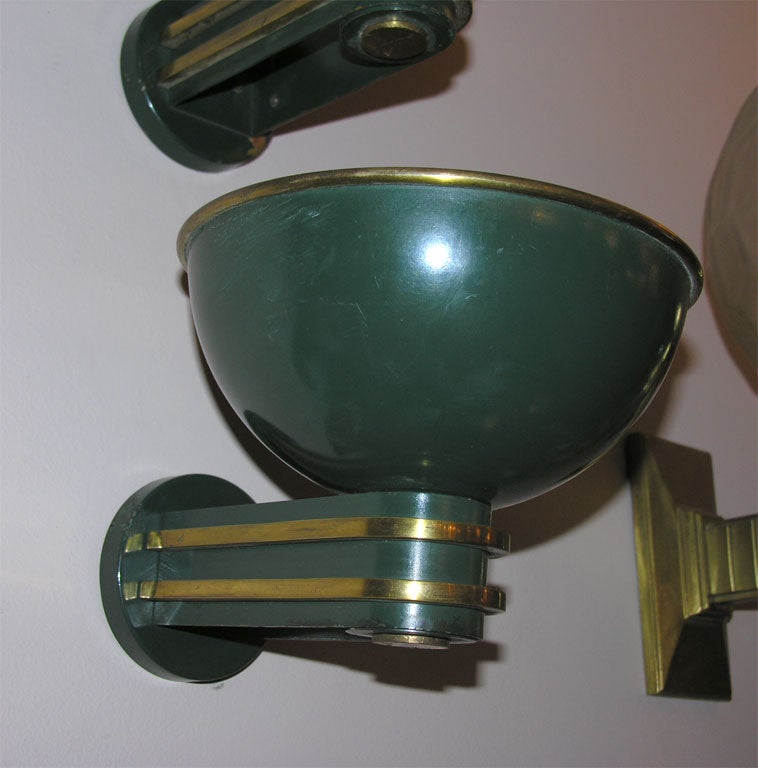 A pair of green lacquered and gilded bronze wall sconces designed by Paul Follot, circa 1930.