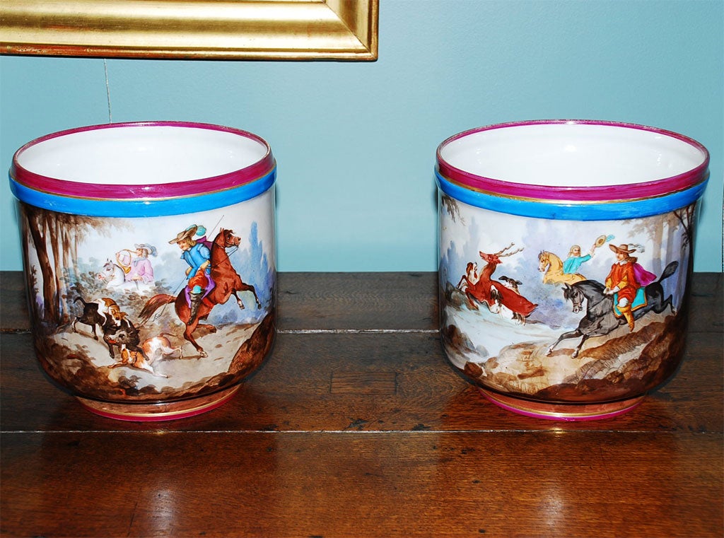 Pair of Paris porcelain jardinieres or planters, beautifully detailed hunting scenes of riders on horseback chasing a boar and a stag with dogs.