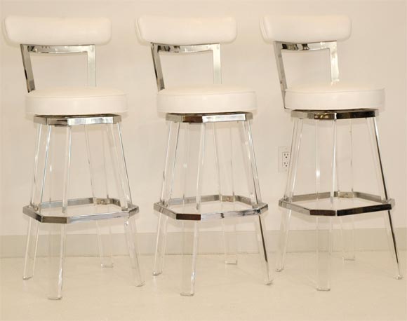 These great bar stools are ready to go.  Newly reupholstered in White Faux Lizard, these stools swivel as well. Excellent quality sets these stools apart from the ordinary.  Listed price is per stool.
