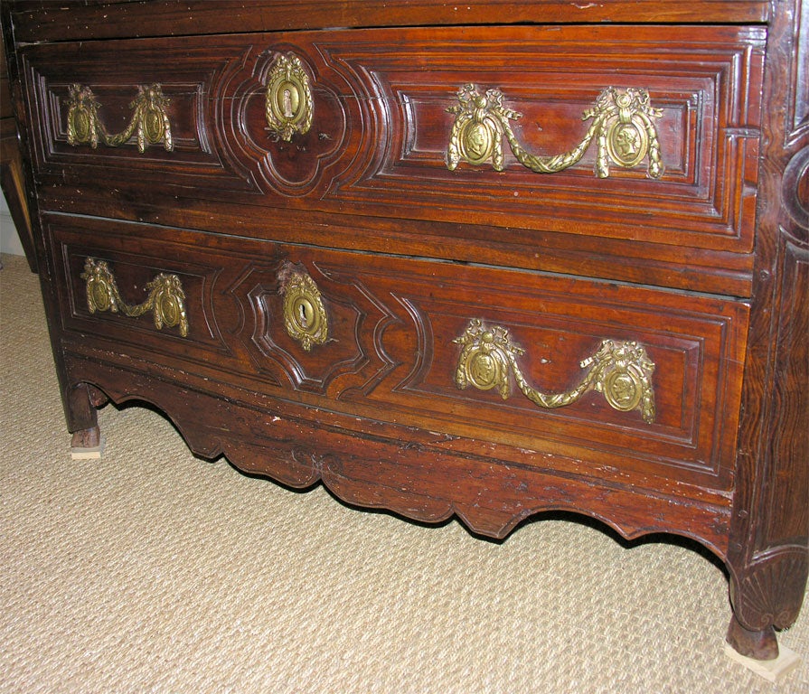 A mid 18th century French Louis XV commode, in wild cherry, from the Brittany region, with carved and molded drawer fronts, shell carved feet, and original wood top. (Provenance: Collection of Pierre Moulin, founder of Pierre Deux).