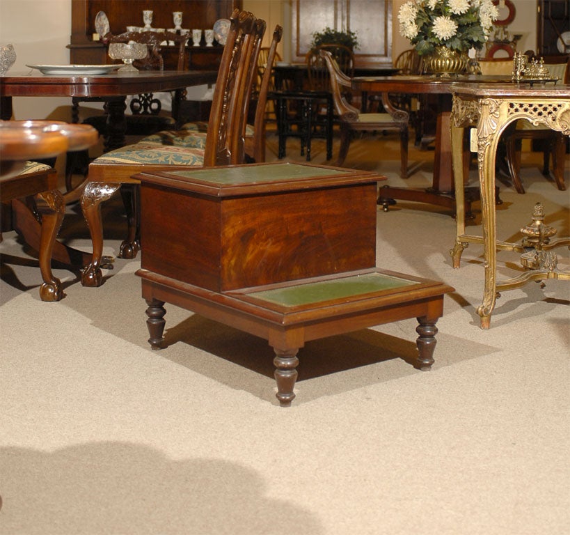 English mahogany bed steps with green leather tooled and gilded surfaces.   Top step opens originally for champer pot,<br />
now can be used for storage.   Turned legs.  Good antique patina.    Would alternatively make good library steps or side
