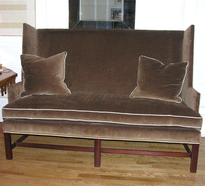 High-back shelter settee in brown velvet with contrasting welt. Spring down seat with two goose feather pillows. Available in other sizes and fabrics.