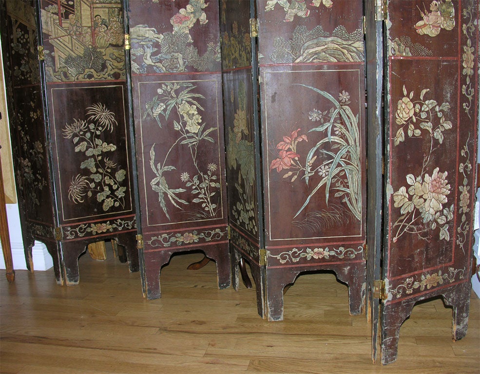 This reversible hand-painted screen has one side depicting scenes from early life in China. The reverse side is adorned with a whimsical bird and floral motif. 8 Panels - 12