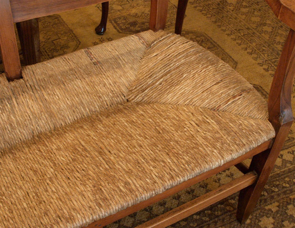 Fruitwood Antique French provincial rush seat fruitwood bench.