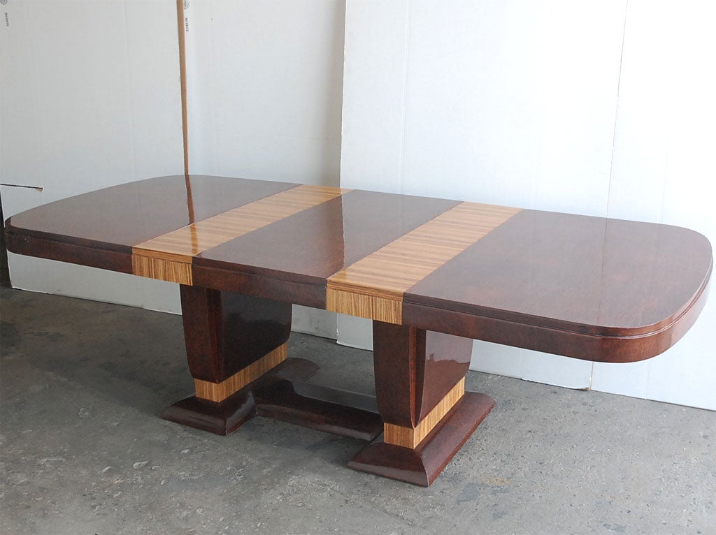 French Art Deco double-pedestal dining table in rare redwood burl veneers with stepped top detail, radiused corners, and zebrawood veneer details at base of pedestals. Expandable with 1 original burlwood leaf at 19.5