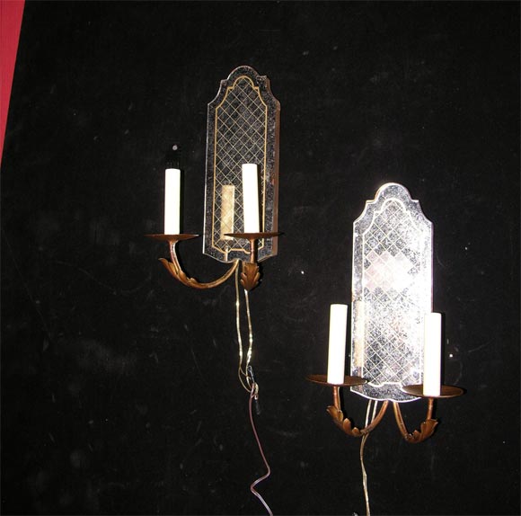 Etched gold lattice mirrored back pair of two light sconces.