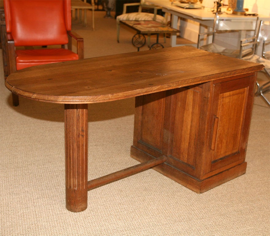 Here is an oak desk with a rounded pedestal front The inside has 3 drawers and the outside has a door with shelving. Chic.