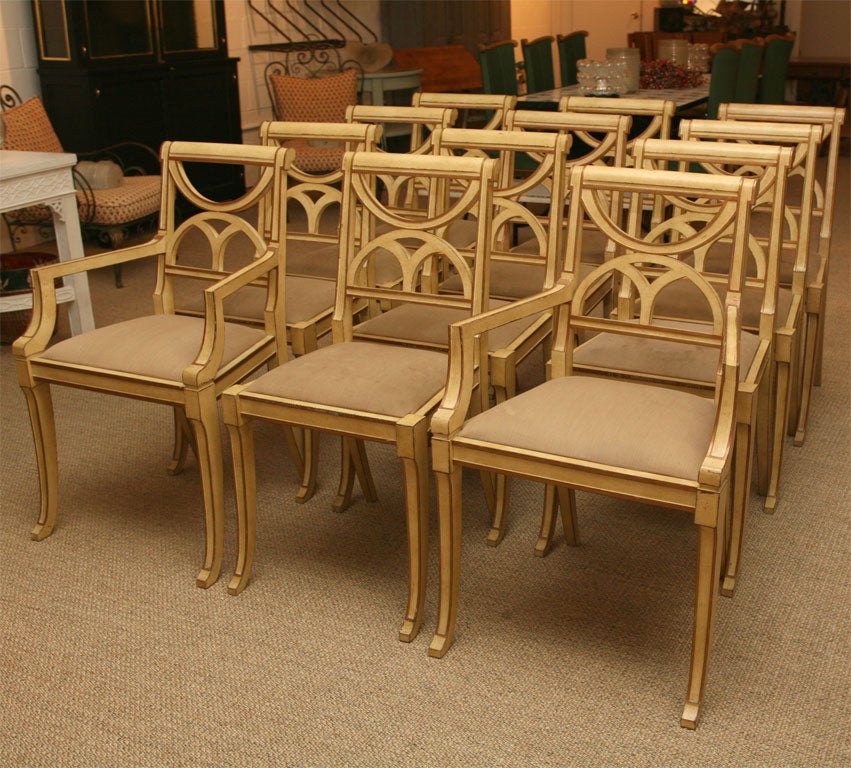 painted regency style dining chairs-2 arm and 10 sides mellow cream color with gilded accents-slip seats-sabor legs