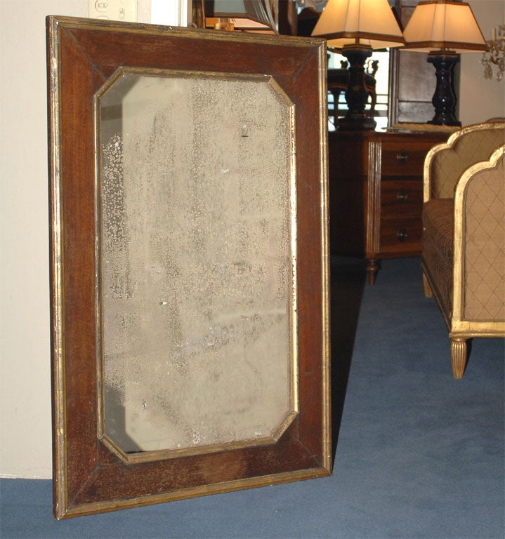 The elongated octagonal mirror plate within a molded giltwood inner and outer frame.
