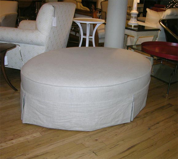 Tailored oval ottoman with dress makers skirt and cord trim. Upholstered in beige linen or your own material.