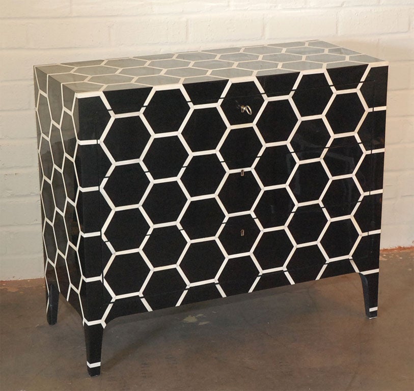 Striking lacquered black & white bone three-drawer chest.