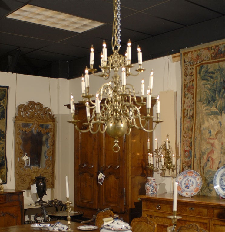 A large and elegant Dutch Chandelier in Brass, featuring three tiers of candle-arms & central column ending in a globe. <br />
<br />
Each meandering branch ending in a candle-holder, and each tier with 6 lights evenly-spaced around the central