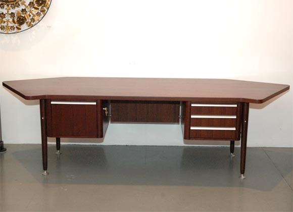 Large Stow Davis desk with curved top and polished aluminum hardware and detail.  Desk has generous drawer space with three smaller drawers on the right and one file drawer on the left.  Handsome executive desk for a large space!