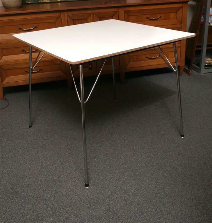 Fantastic Vintage Eames Folding Table from the early 1950's with a white Micarta top, chrome folding legs and hair-pin support arms.  Named the DTM-20, its simplicity, great clean looks and folding utility made it an Eames classic with production by