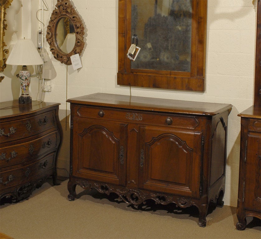 A fine Louis XV Buffet, constructed in Walnut, and accented with pierced Steel escutcheon plates & decorative mounts. Provencal in origin, and dating from the mid-18th century. 

The commode's most notable design feature is the exceptional pierced
