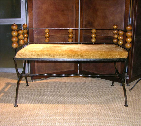 Black iron bench with wooden balls