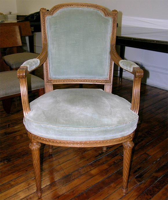 A pair of Louis XVI style armchairs by Jansen.  Light blue-green velvet upholstery.  Carved 