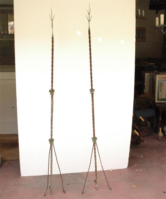 Pair of wonderful lightning rods with twisted metal stakes topped with bronze branch forms. Rods are held up with rustic metal tripod stands and glass insulators. Wonderful architectural pieces.