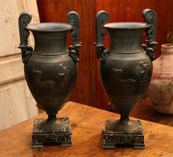 Beautifully cast with great detail bronze Charles X urns on marble plinths.