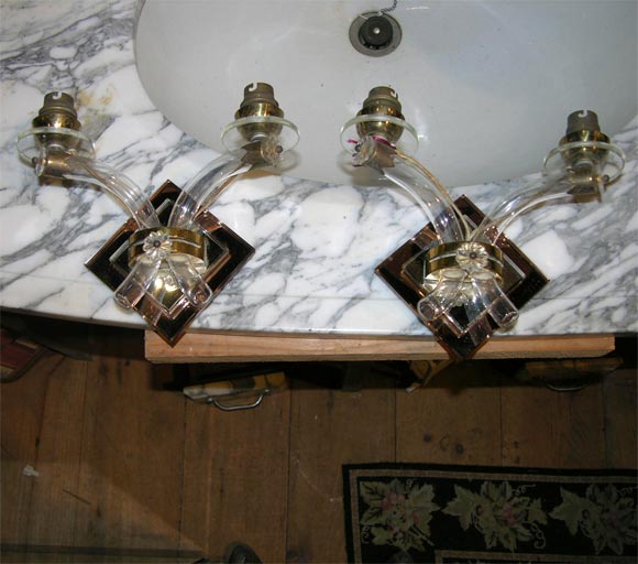 Pair of small pink mirror and clear mirror back sconces with blown glass arms and lucite bobeches.