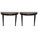 A Pair of Black Demi-Lune Consoles with Gold Detail