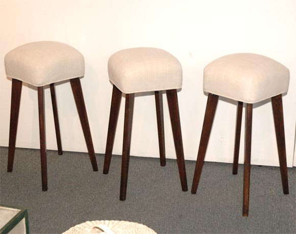 1930S BAR STOOLS WITH LINEN SEATS AND TAPER LEGS/SET OF THREE